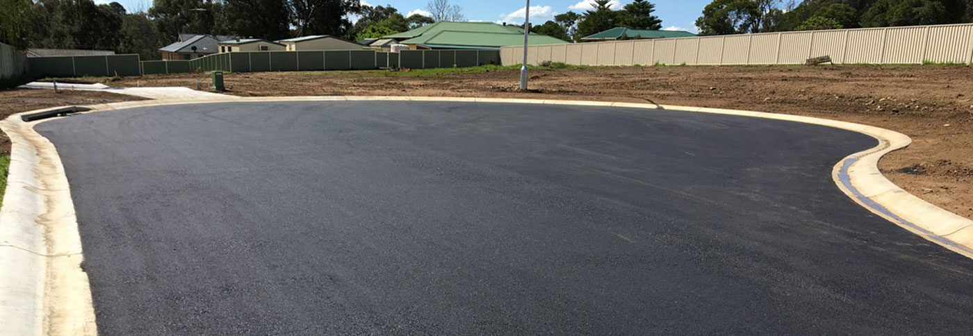 A driveway being paved in a residential area.